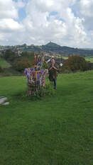 Bruce Clifton standing next to The Glastonbury Thorn at Glastonbury. With The Tor in the background