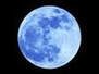 Picture of a full moon set against a black background, the moon is a deep blue.